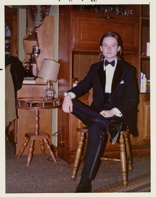 Lou Sullivan sits dramatically, and somewhat seriously, in a tuxedo with his hair slicked back behind his ears, stylishly. Lou Sullivan pictured in 1974 before attending the GPU’s drag ball.